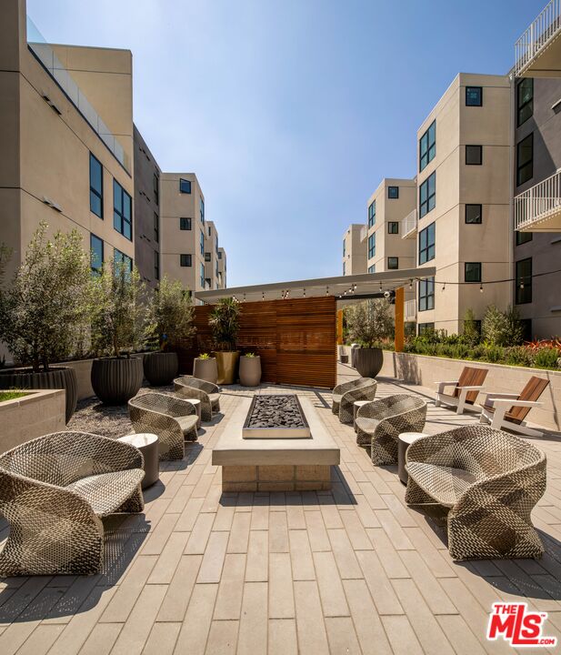 1101 North Main Street, Unit C450 Los Angeles, CA 90012 - Photo 22 of 35 a terrace of a building with couches potted plants and wooden walls