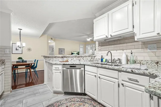 a kitchen with stainless steel appliances granite countertop a sink and cabinets