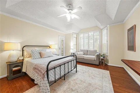 a bedroom with bed and a couch