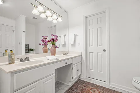 a bathroom with a sink vanity and a mirror