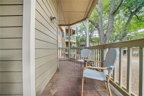 a view of a chair and table in the balcony