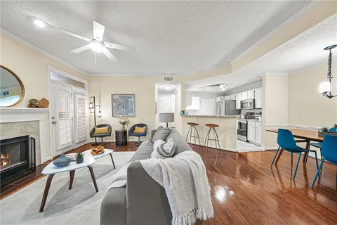 a living room with furniture a fireplace and wooden floor