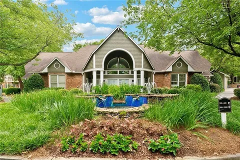 an aerial view of a house with swimming pool and furniture