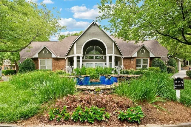 an aerial view of a house with swimming pool and furniture