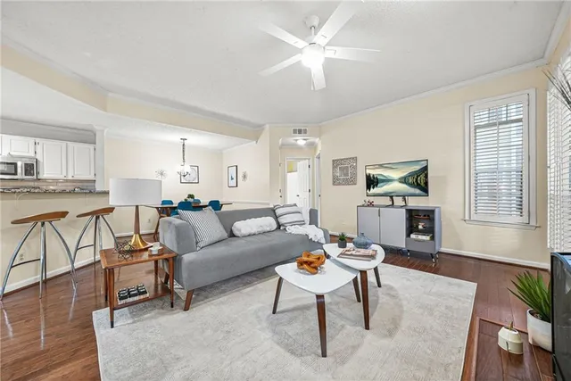 a living room with furniture a dining table and a piano table