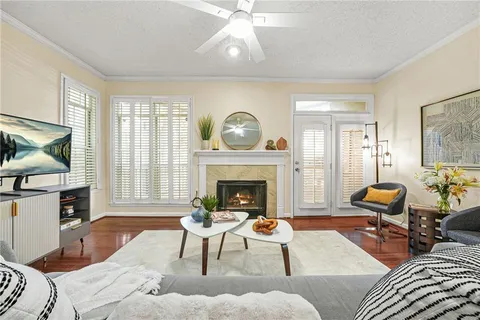 a living room with furniture a fireplace and a flat screen tv