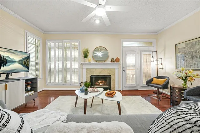 a living room with furniture a fireplace and a flat screen tv