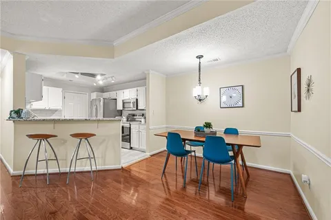 a view of a dining room with furniture and wooden floor