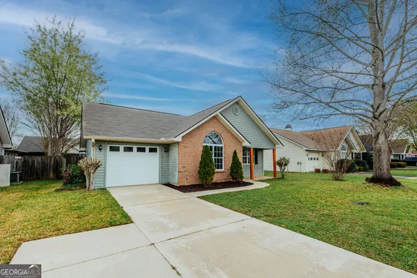 a front view of house with yard and green space
