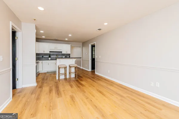 a kitchen with stainless steel appliances a refrigerator and a stove top oven