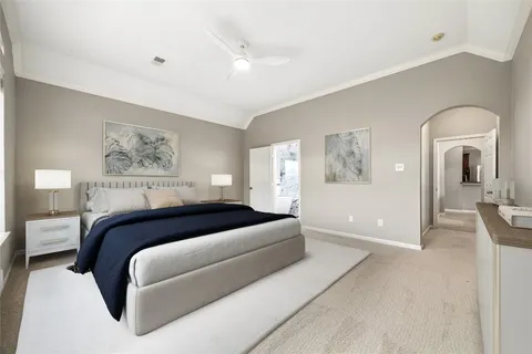 a spacious bedroom with a bed and a couch