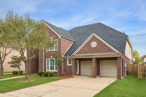 a front view of a house with a garden and plants