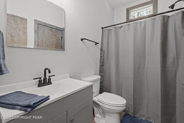 a bedroom with a bed and a view of bathroom