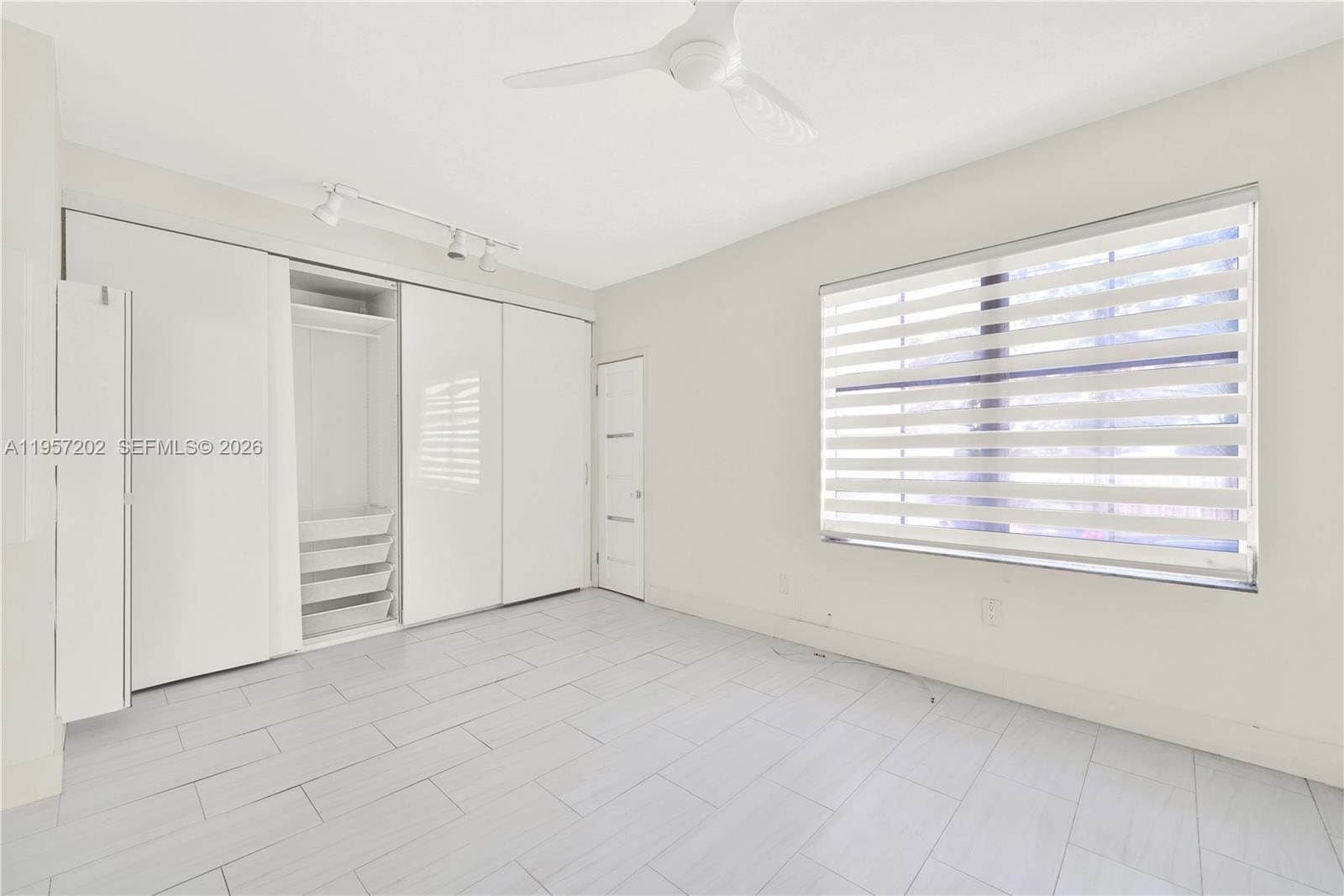 610 8th Street Miami Beach, FL 33139 - Photo 15 of 22 a view of an empty room with a window