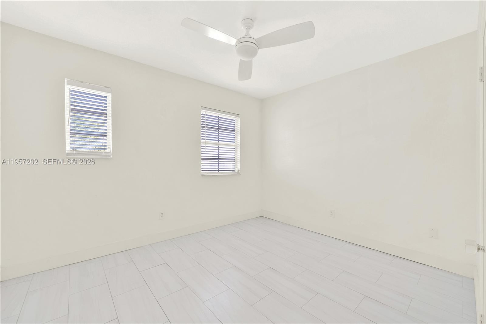 610 8th Street Miami Beach, FL 33139 - Photo 19 of 22 an empty room with a window and a ceiling fan