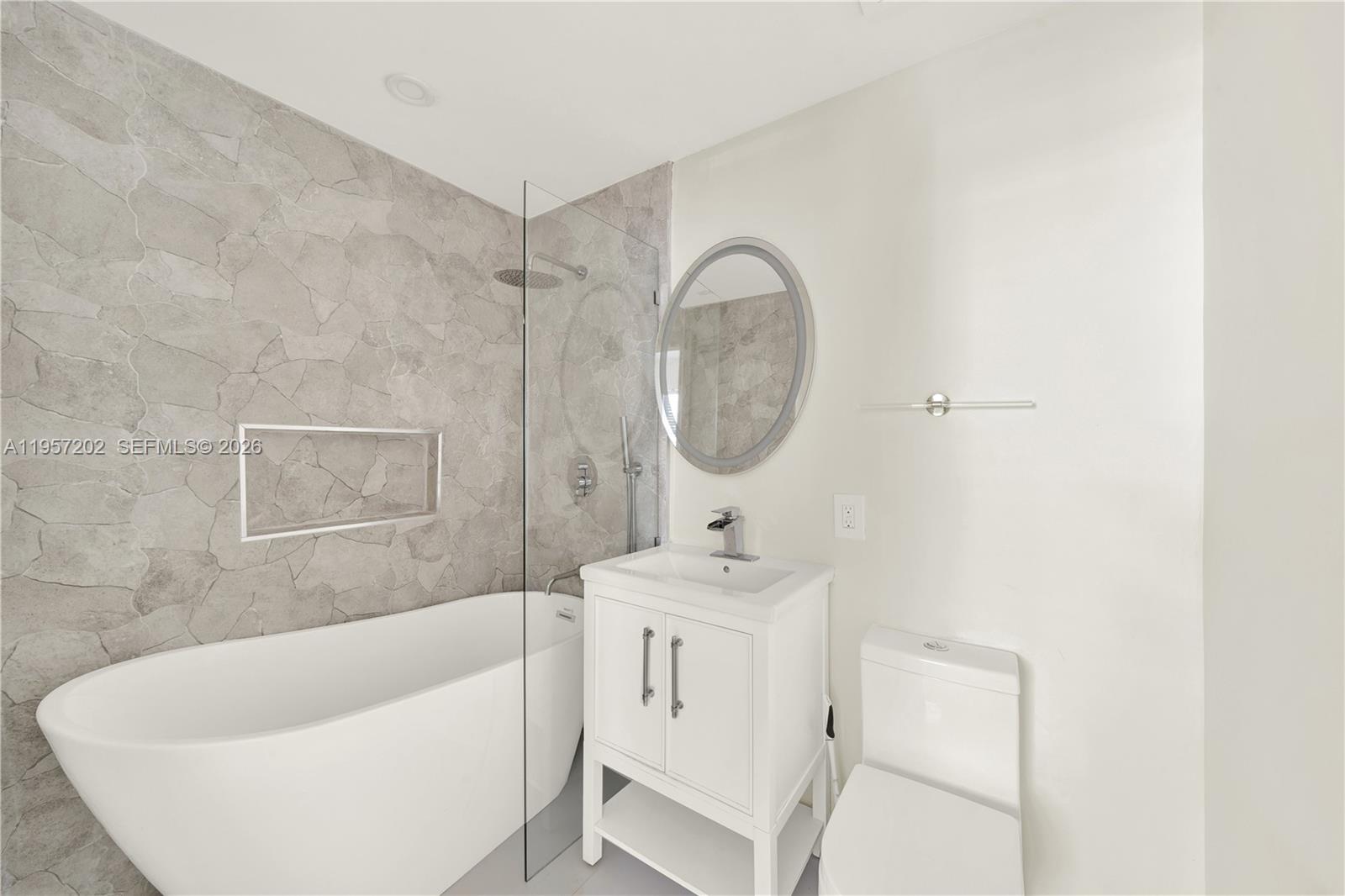610 8th Street Miami Beach, FL 33139 - Photo 22 of 22 a bathroom with a sink a bathtub and a mirror