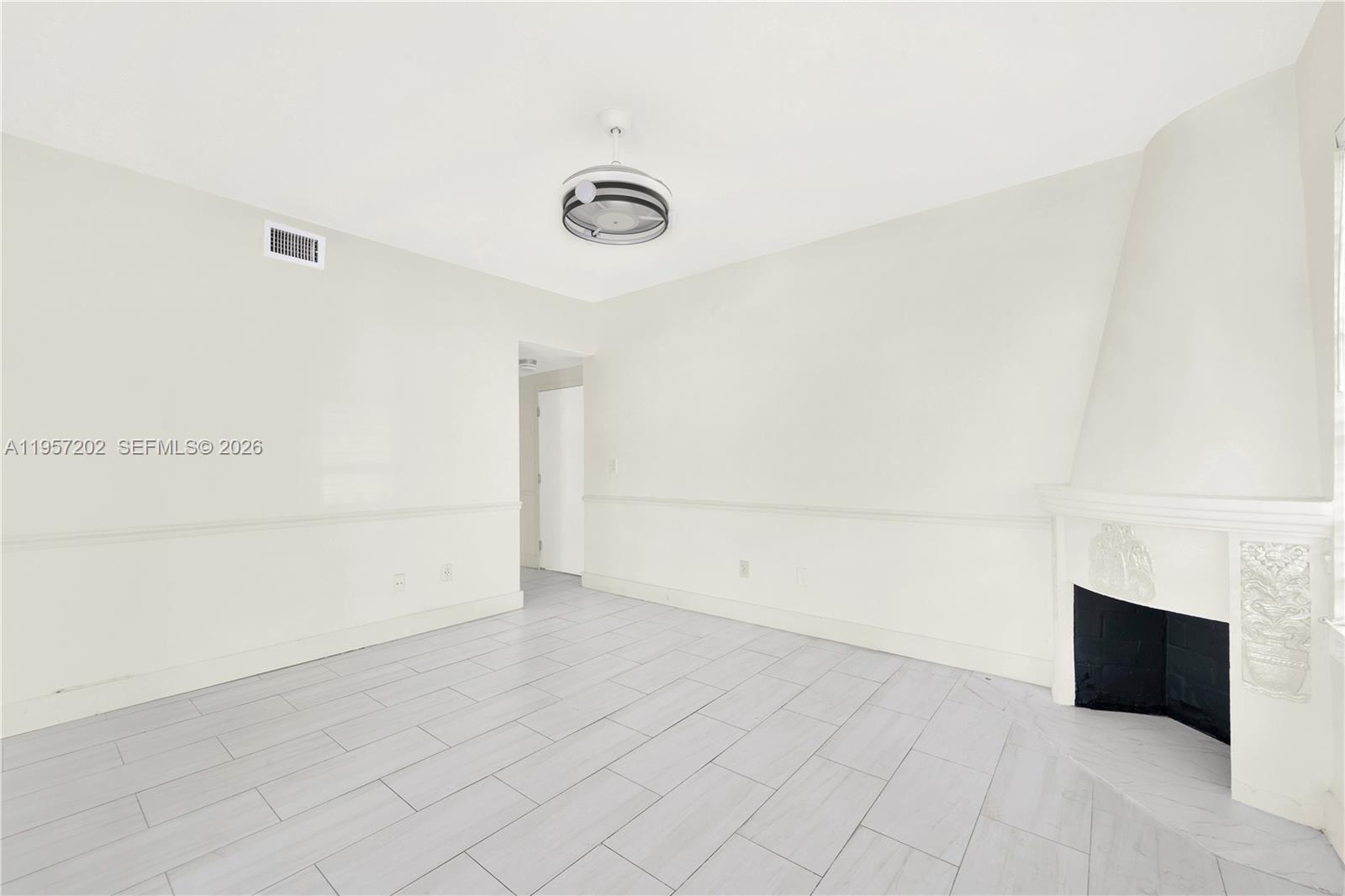 610 8th Street Miami Beach, FL 33139 - Photo 6 of 22 an empty room with a empty space and windows