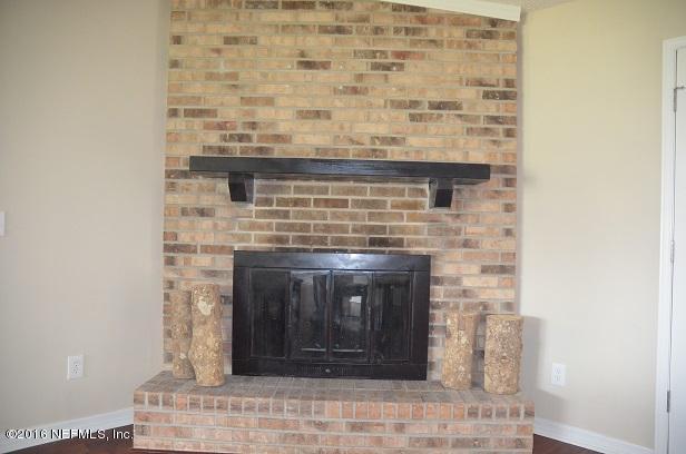 10982 Reading Road Jacksonville, FL 32257 - Photo 15 of 27 a fireplace with a clock on it
