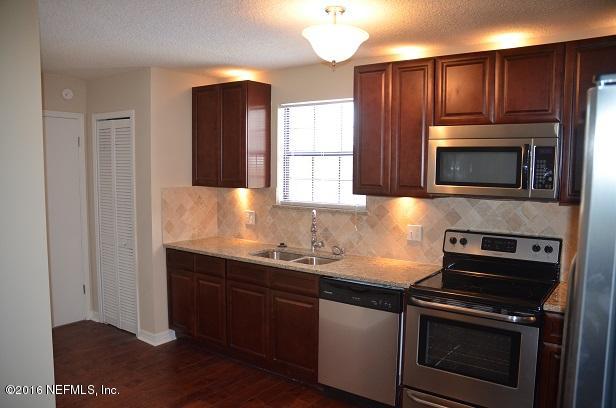 10982 Reading Road Jacksonville, FL 32257 - Photo 8 of 27 a kitchen with sink a microwave a stove and cabinets
