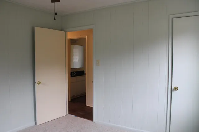 a view of a hallway with wooden shelves