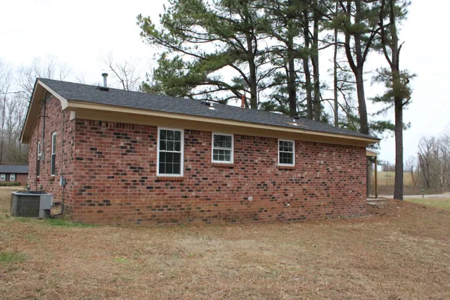 front view of a house with a large tree
