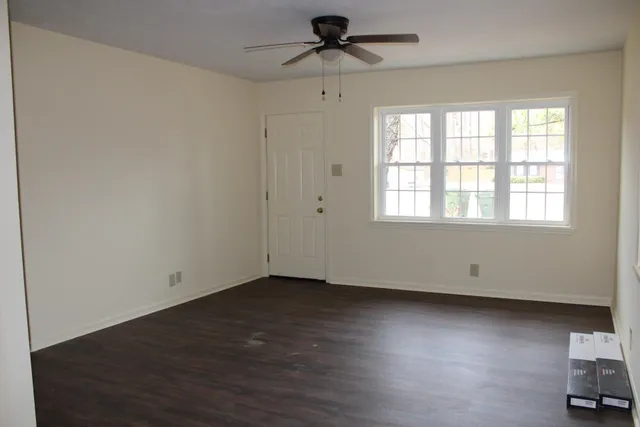 wooden floor in an empty room with a window