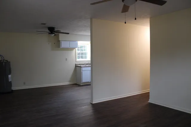 a view of a room with wooden floor and a window