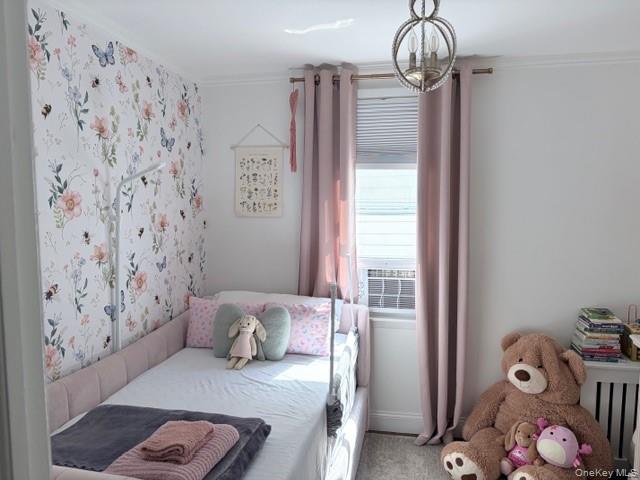 78-18 65th Street Queens, NY 11385 - Photo 12 of 25 a bedroom with a bed and a chandelier