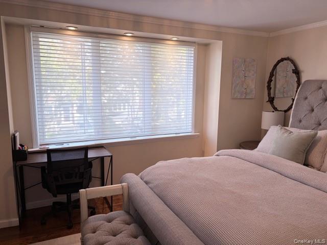 78-18 65th Street Queens, NY 11385 - Photo 14 of 25 a bedroom with a bed a table and windows