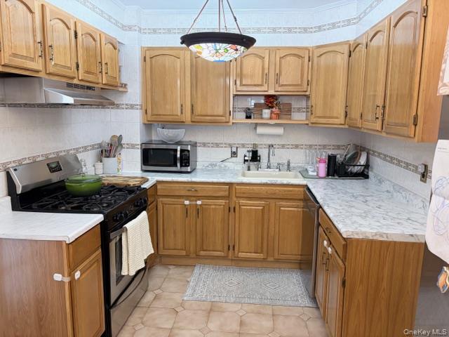 78-18 65th Street Queens, NY 11385 - Photo 2 of 25 a kitchen with stainless steel appliances granite countertop a sink stove and cabinets