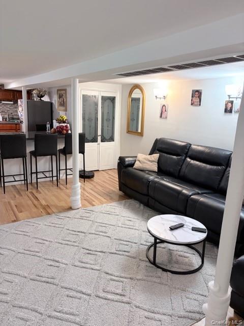 78-18 65th Street Queens, NY 11385 - Photo 21 of 25 a living room with furniture and a large window