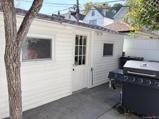78-18 65th Street Queens, NY 11385 - Photo 22 of 25 a view of a house with a door and a tree