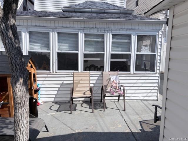 78-18 65th Street Queens, NY 11385 - Photo 23 of 25 a view of a patio with table and chairs with wooden floor and fence