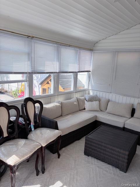 78-18 65th Street Queens, NY 11385 - Photo 24 of 25 a living room with furniture a table and kitchen view