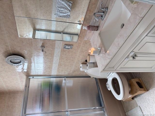 78-18 65th Street Queens, NY 11385 - Photo 7 of 25 a bathroom with a granite countertop toilet sink and mirror