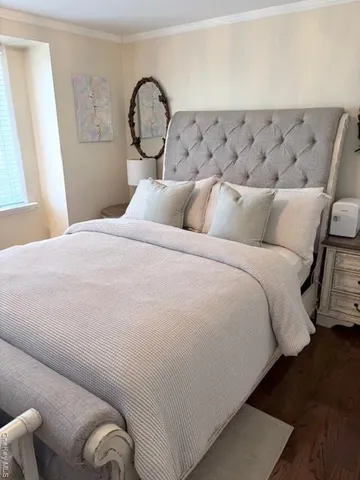 a large bed sitting in a bedroom next to a window