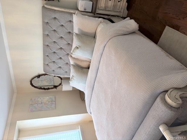 78-18 65th Street Queens, NY 11385 - Photo 10 of 25 a large bed sitting in a bedroom next to a window