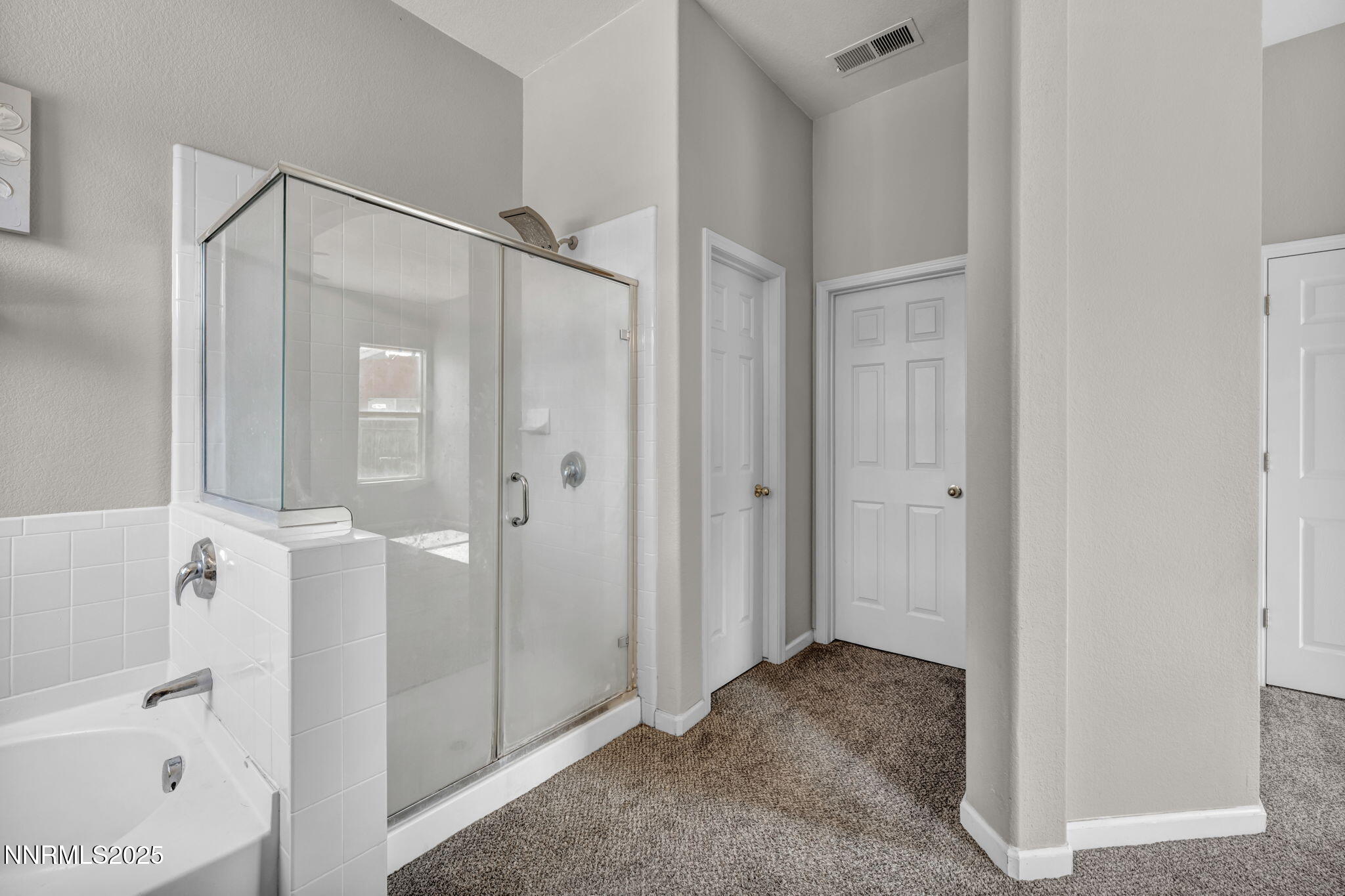 908 Jones Way Fernley, NV 89408 - Photo 12 of 17 a view of a bathroom with a shower and a bath tub