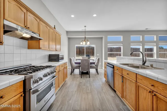 a kitchen with stove a sink and refrigerator