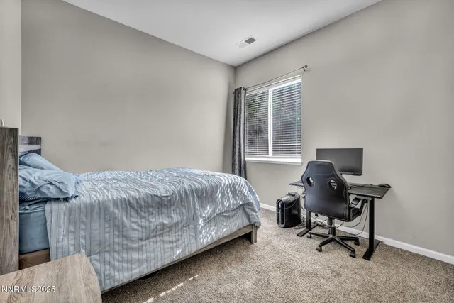 a bedroom with a bed and a desk