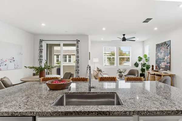 a living room with furniture large window and table