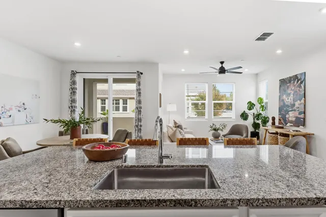 a living room with furniture large window and table
