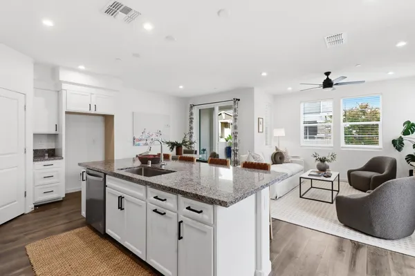 a kitchen with stainless steel appliances granite countertop a sink stove and cabinets