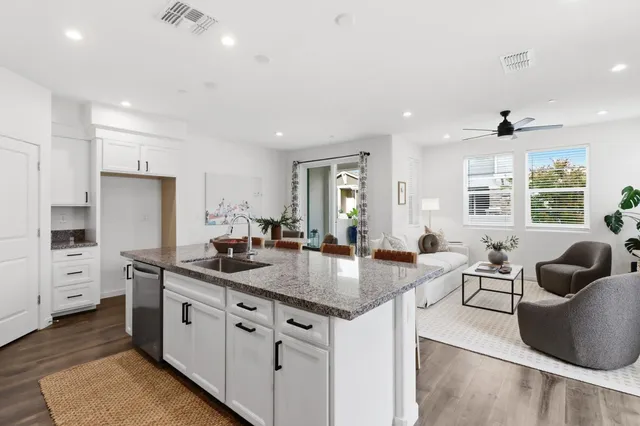 a kitchen with stainless steel appliances granite countertop a sink stove and cabinets