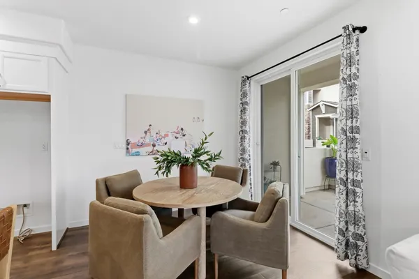 a dining room with furniture and wooden floor