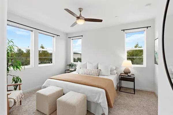 a bedroom with a bed and a window