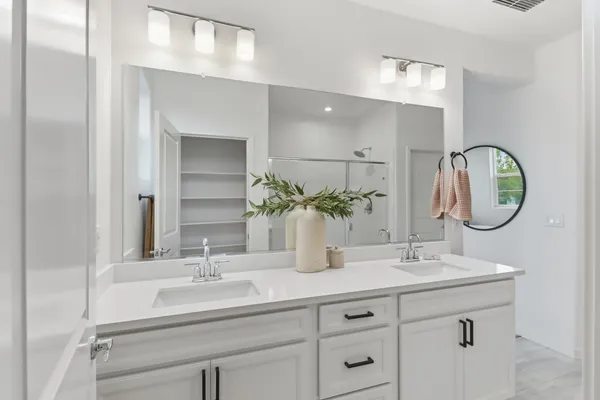 a bathroom with a double vanity sink and a mirror