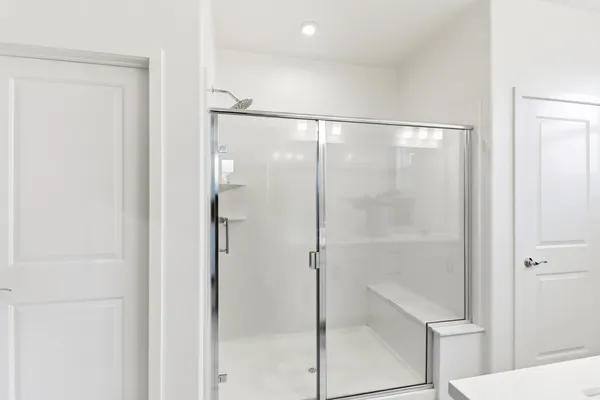 a bathroom with a glass shower door