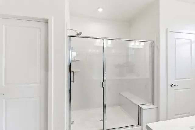 a bathroom with a glass shower door