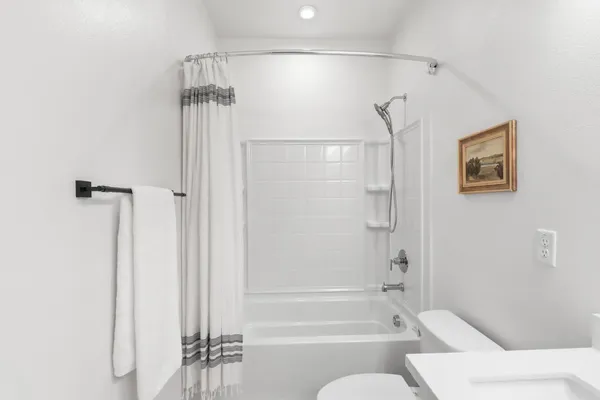 a bathroom with a bathtub and a shower